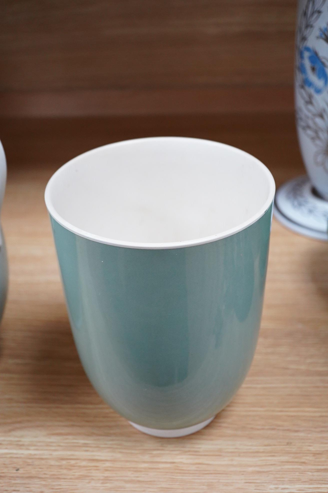 Keith Murray for Wedgwood, three celadon slipware vases, one with twin handles, largest 27cm high